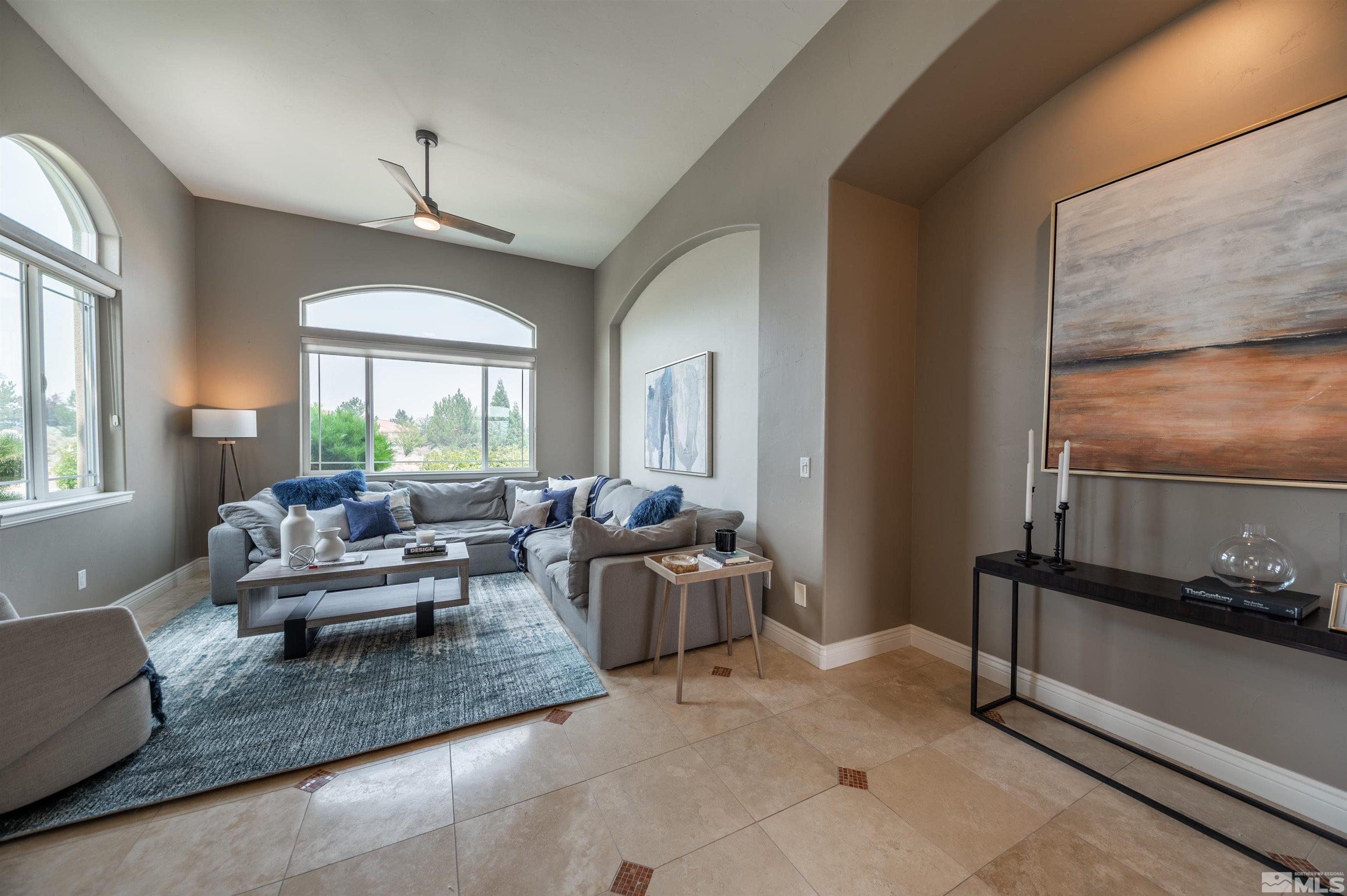 12880 Silver Wolf Road Reno, NV 89511 - Photo 3 of 35 a living room with furniture windows and a chandelier