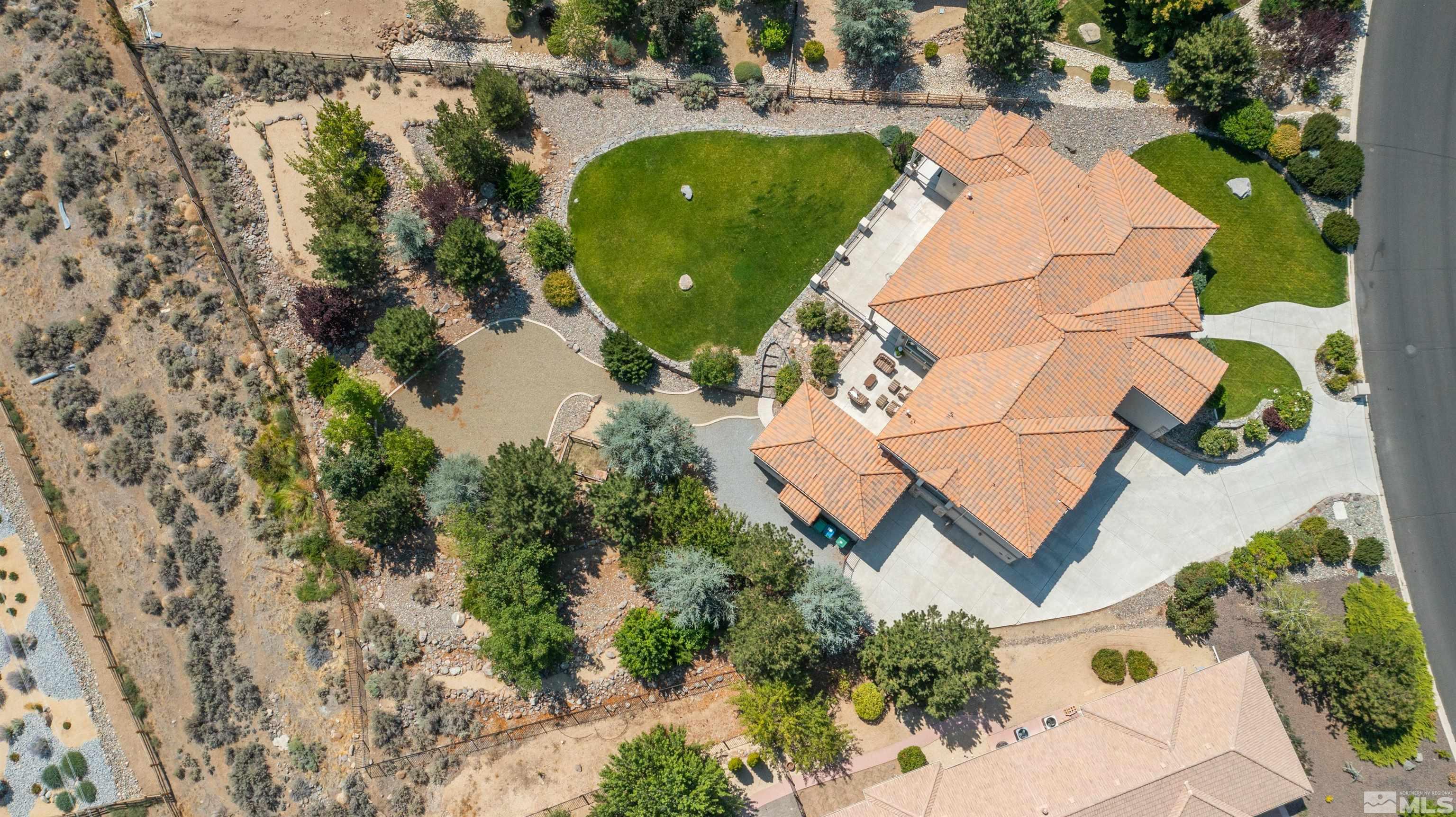 12880 Silver Wolf Road Reno, NV 89511 - Photo 28 of 35 an aerial view of a house with a yard and trees all around