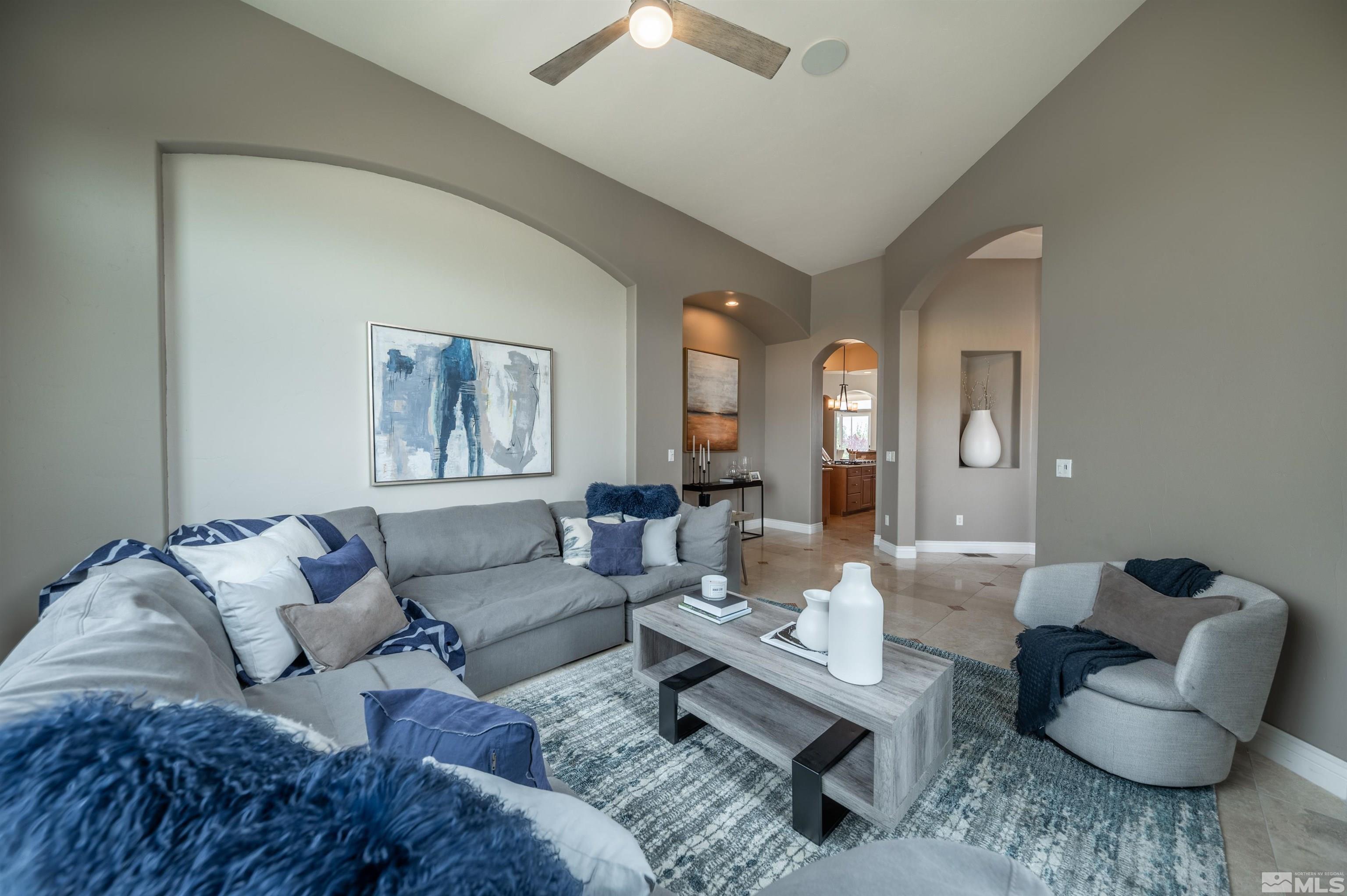 12880 Silver Wolf Road Reno, NV 89511 - Photo 4 of 35 a living room with furniture and a large mirror