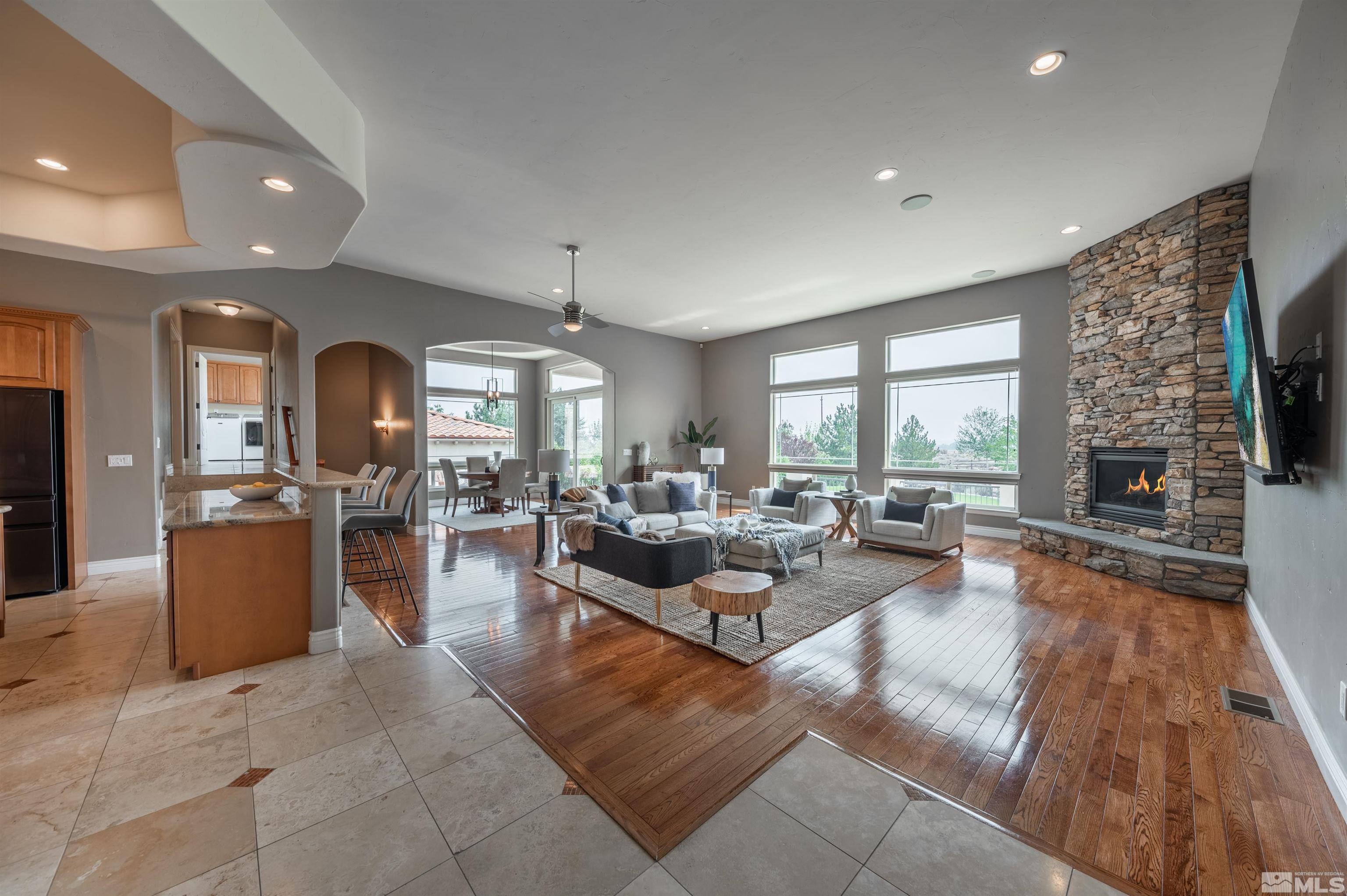 12880 Silver Wolf Road Reno, NV 89511 - Photo 5 of 35 a living room with fireplace furniture and a flat screen tv