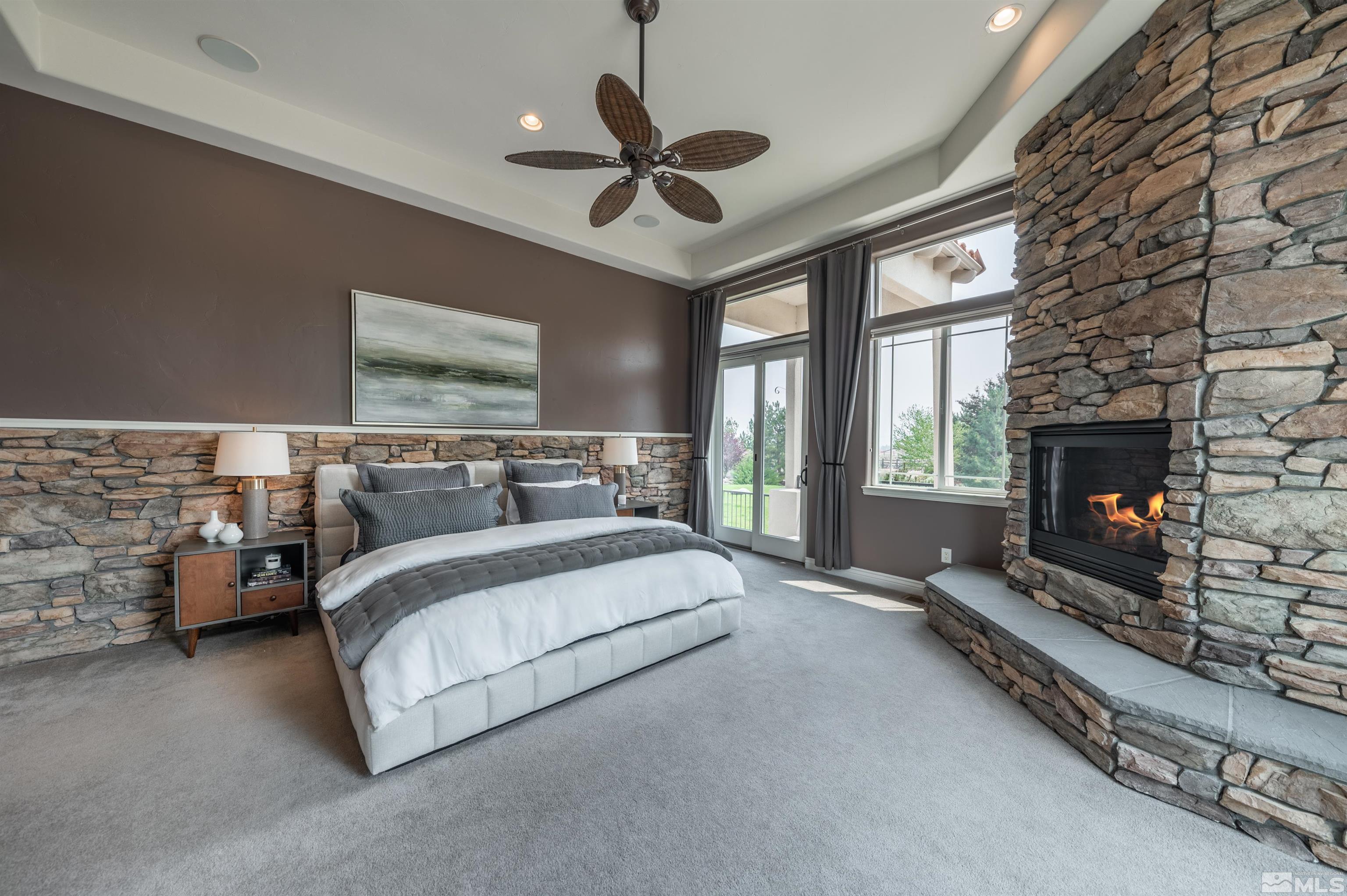 12880 Silver Wolf Road Reno, NV 89511 - Photo 10 of 35 a spacious bedroom with a bed and a fireplace