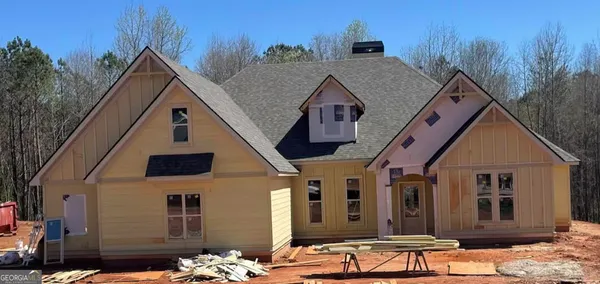 a view of a house with wooden fence