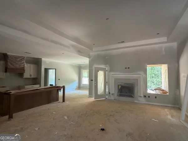 a kitchen that has a lot of cabinets in it and wooden floors