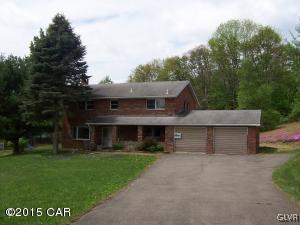 a front view of house with a garden