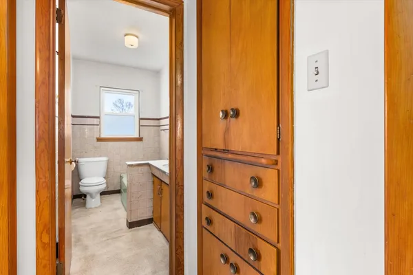 a bathroom with a sink a toilet and mirror