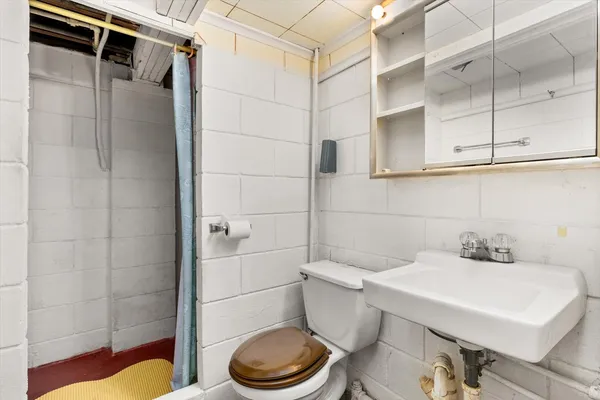 a kitchen with a refrigerator a stove a sink dishwasher and wooden cabinets