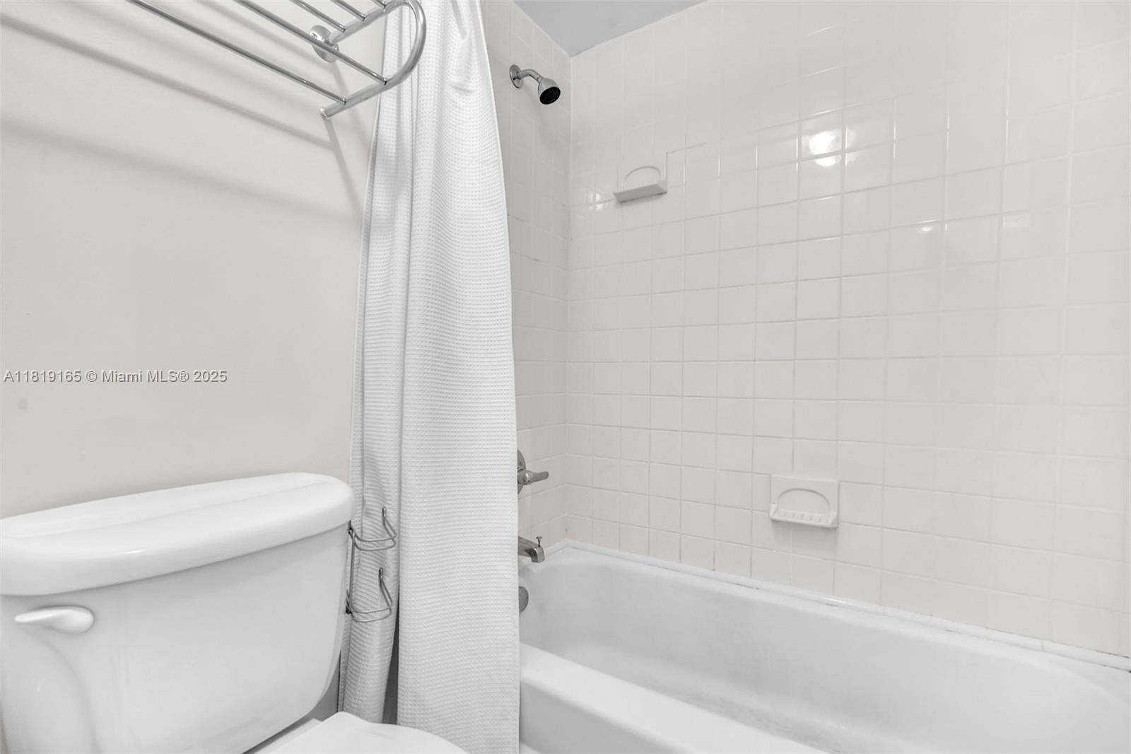 17800 Atlantic Boulevard, Unit 303 Sunny Isles Beach, FL 33160 - Photo 16 of 26 a bathroom with a toilet and a bathtub