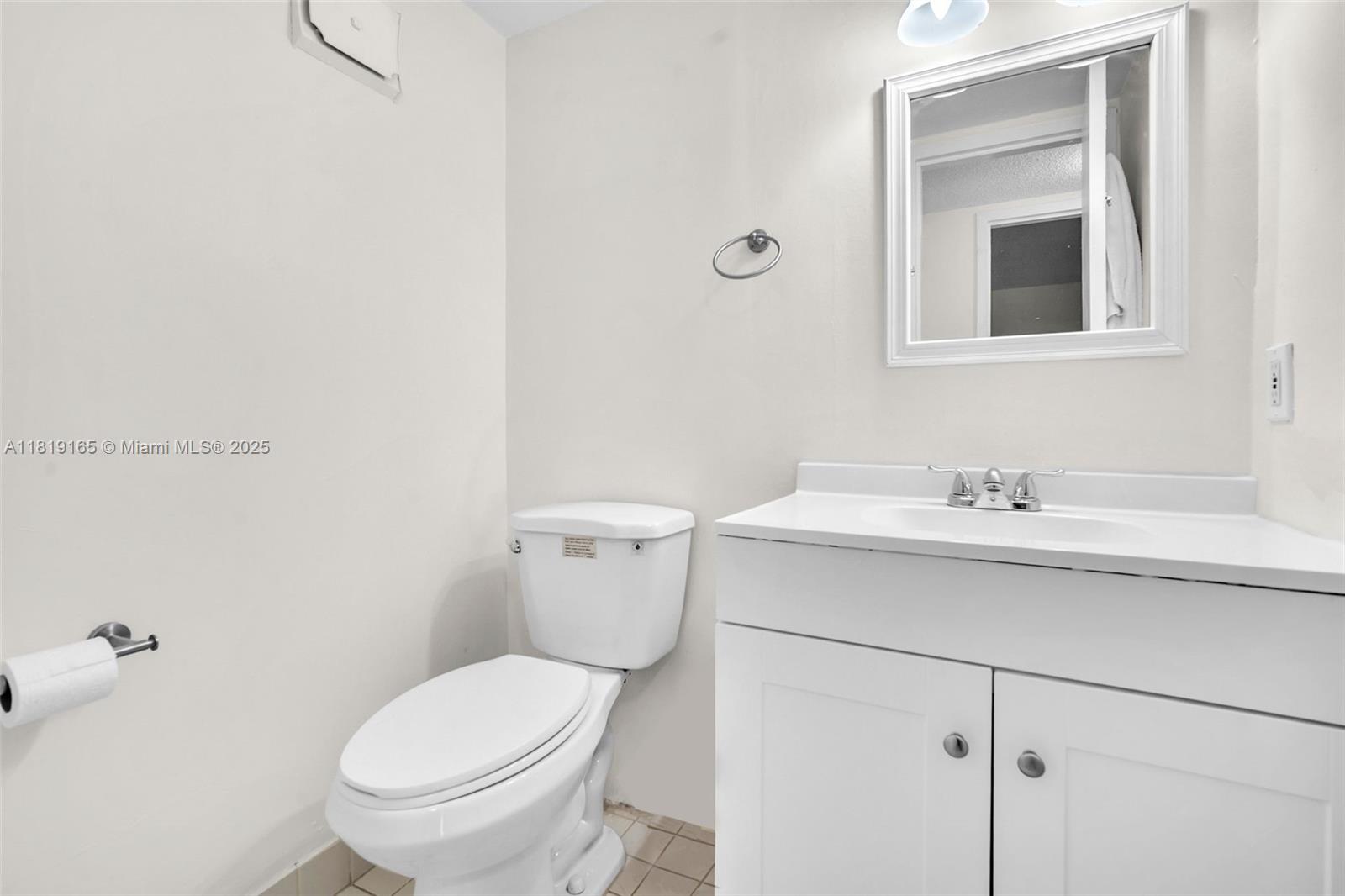 17800 Atlantic Boulevard, Unit 303 Sunny Isles Beach, FL 33160 - Photo 18 of 26 a bathroom with a sink toilet and vanity