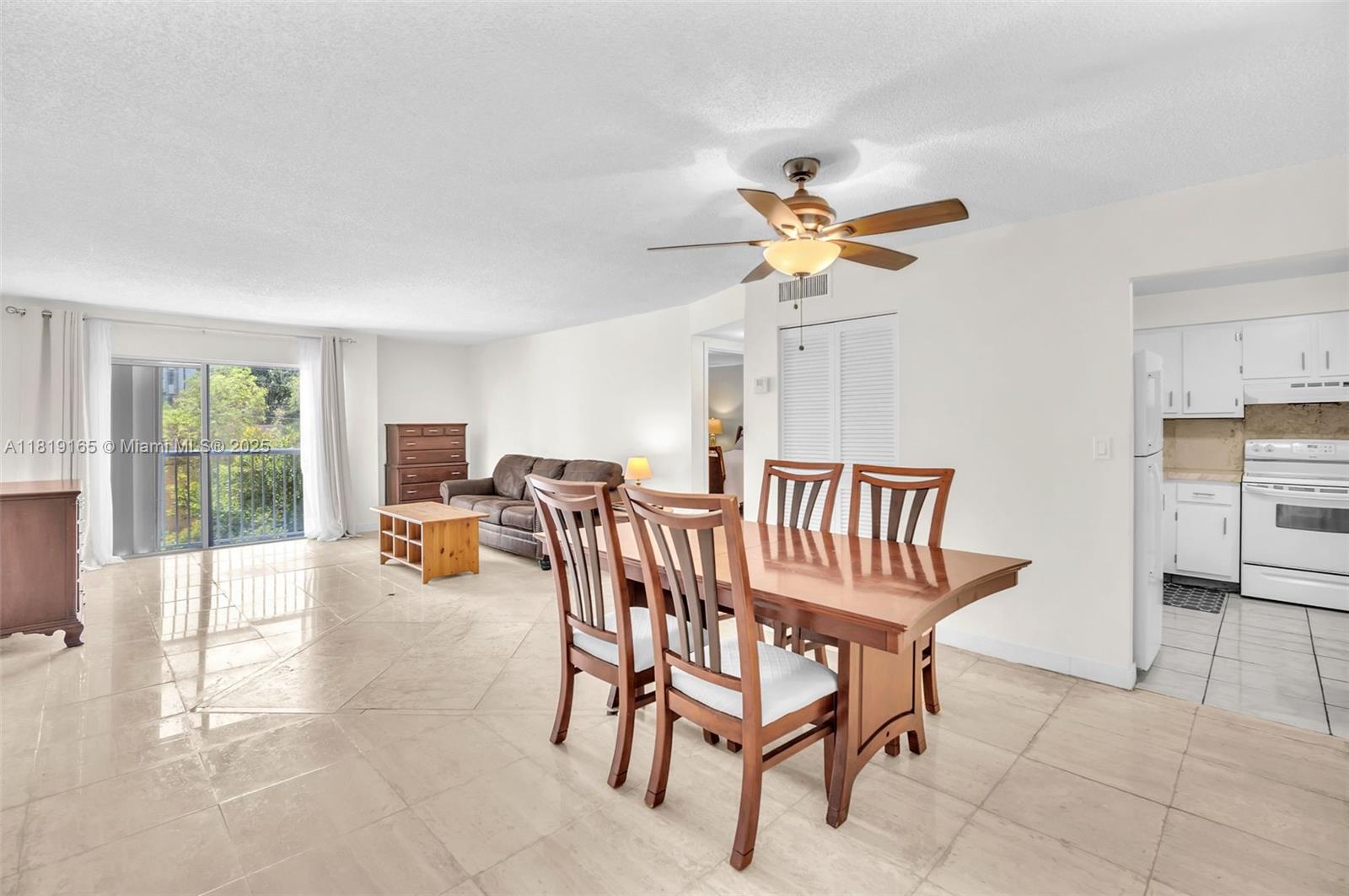 17800 Atlantic Boulevard, Unit 303 Sunny Isles Beach, FL 33160 - Photo 3 of 26 a view of a livingroom with furniture and a ceiling fan