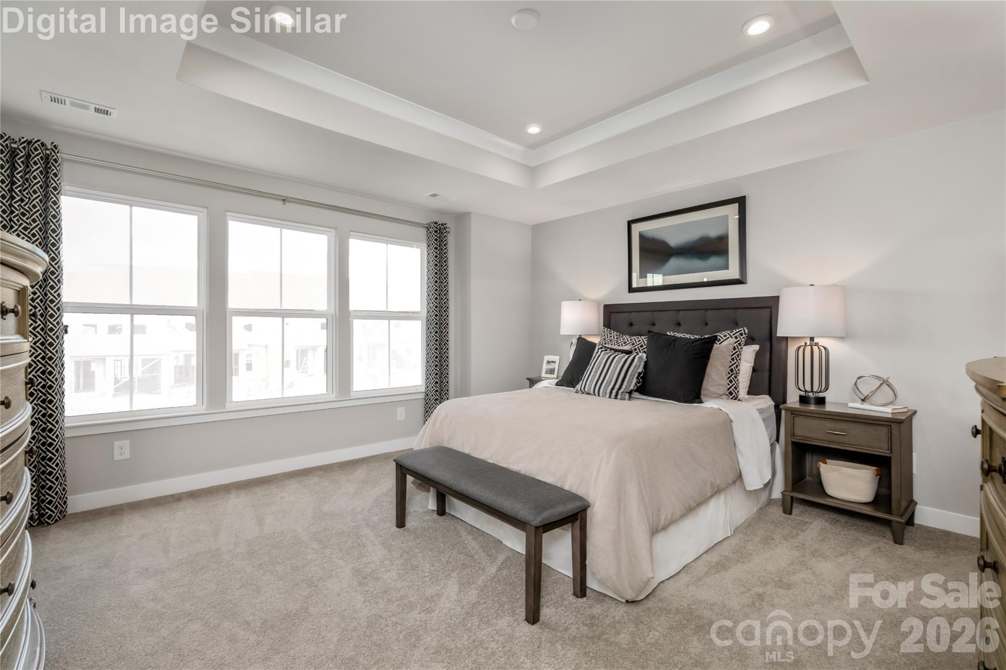 9557 Teamwork Street Northwest Concord, NC 28027 - Photo 8 of 23 a bedroom with a bed a table and painting