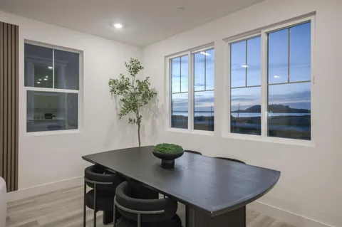 a view of a dining room with a table and chairs