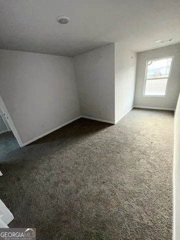 a view of a big room with closet and windows