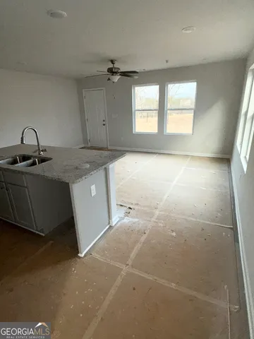 a kitchen with a sink cabinets and utility