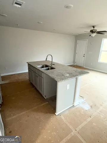 a kitchen with a sink cabinets and appliances