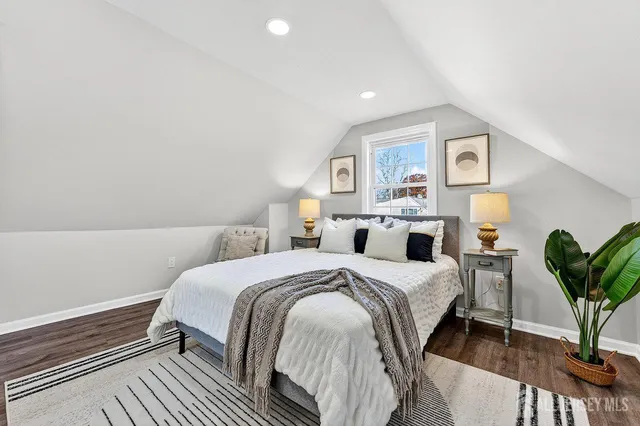 a bedroom with a bed and a potted plant