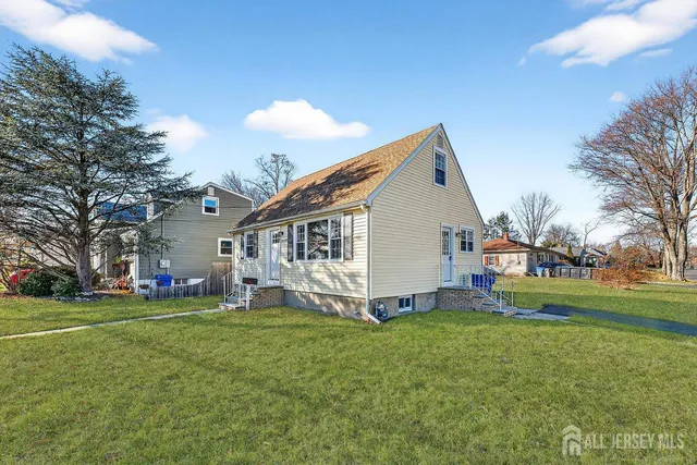 a view of a house with a big yard and large trees