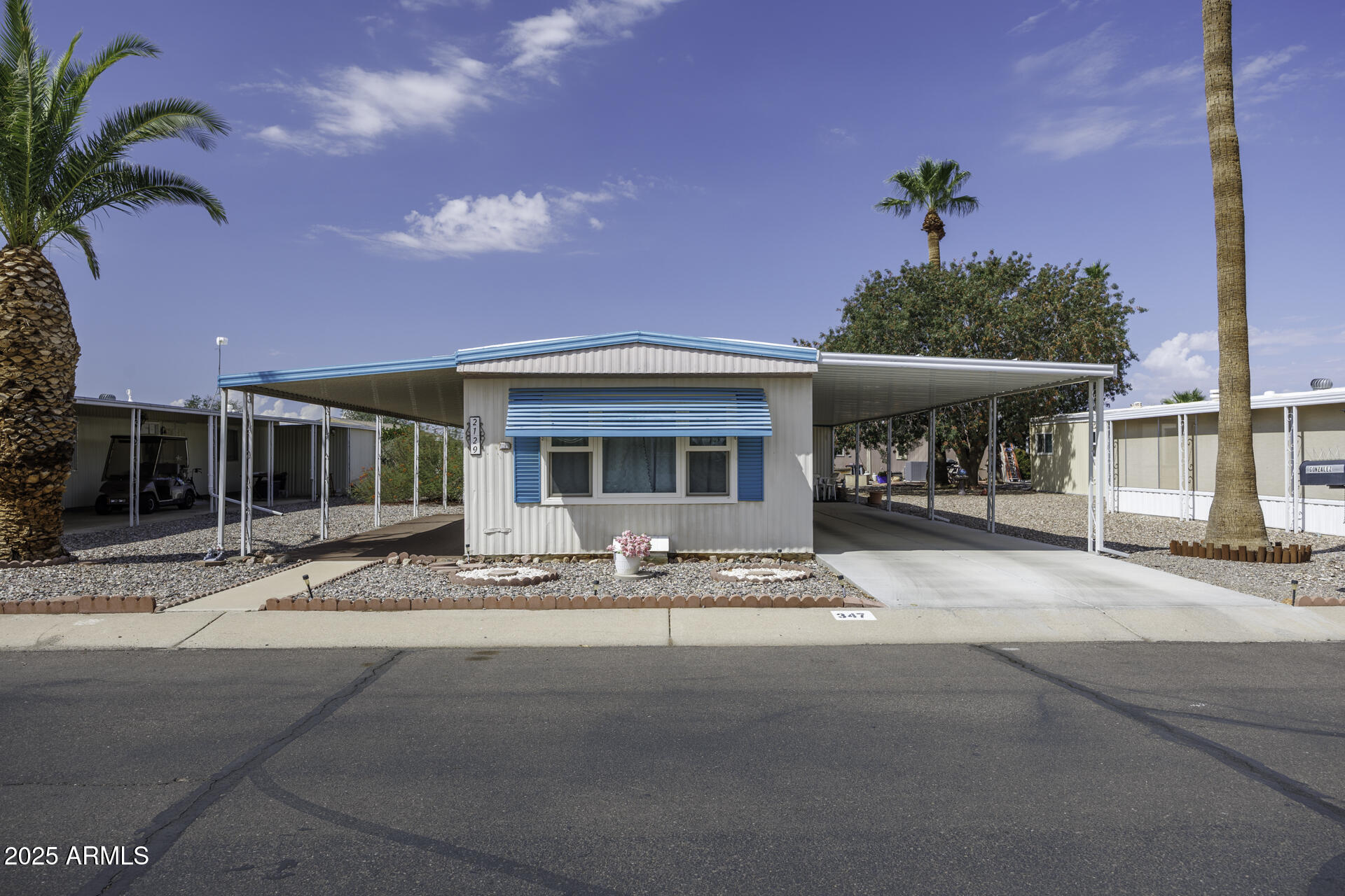 2100 North Trekell Road, Unit 347 Casa Grande, AZ 85122 - Photo 1 of 38 a front view of a house with basket ball court and tables