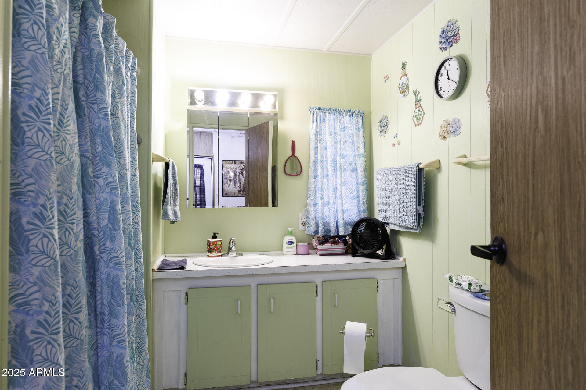 2100 North Trekell Road, Unit 347 Casa Grande, AZ 85122 - Photo 16 of 38 a bathroom with a sink a toilet and a mirror