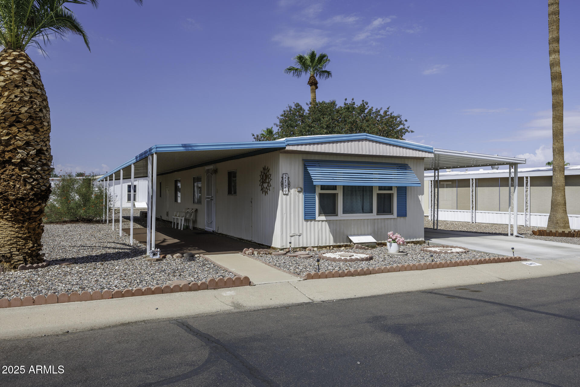 2100 North Trekell Road, Unit 347 Casa Grande, AZ 85122 - Photo 2 of 38 a front view of a house with a garden