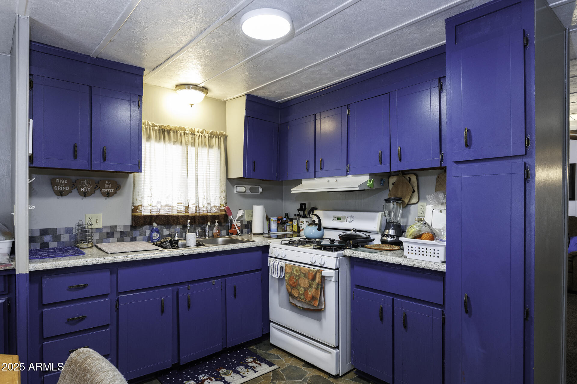 2100 North Trekell Road, Unit 347 Casa Grande, AZ 85122 - Photo 10 of 38 a kitchen with wooden cabinets and white appliances