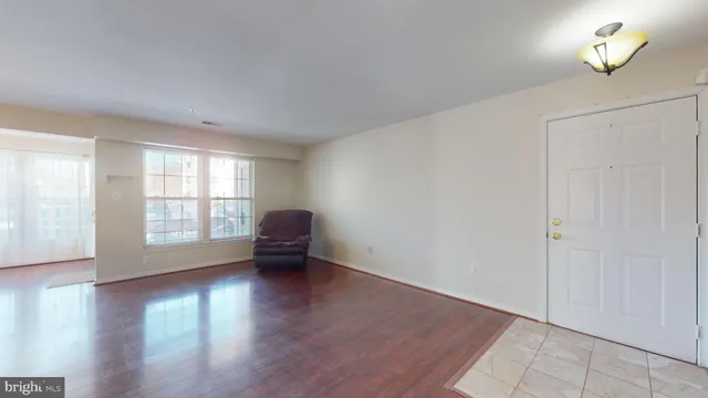 an empty room with piano table and wooden floor
