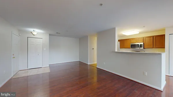 a view of a kitchen with wooden floor and a sink