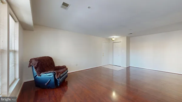 a view of workspace with wooden floor and lounge chair