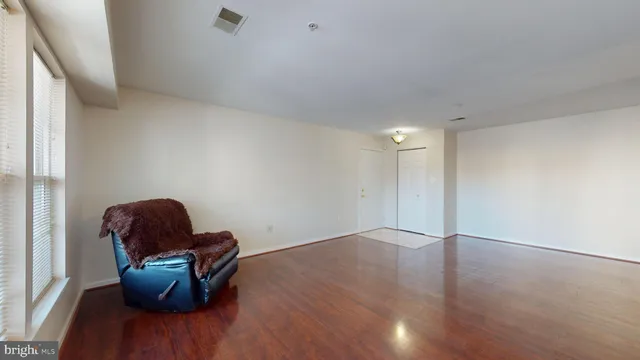 a view of workspace with wooden floor and lounge chair