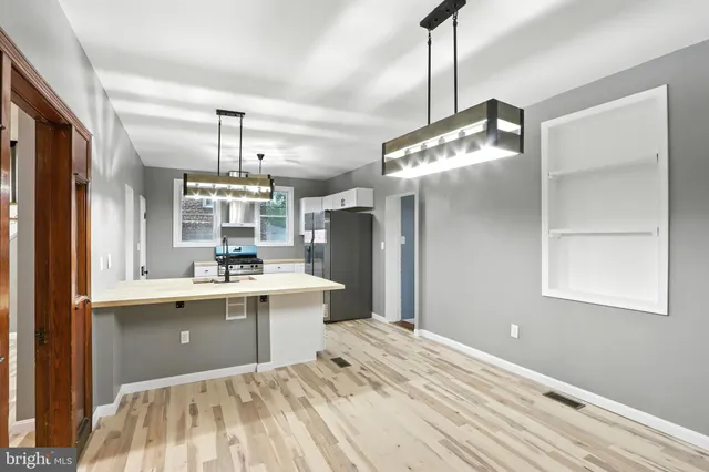 a kitchen with a sink a counter space appliances and cabinets