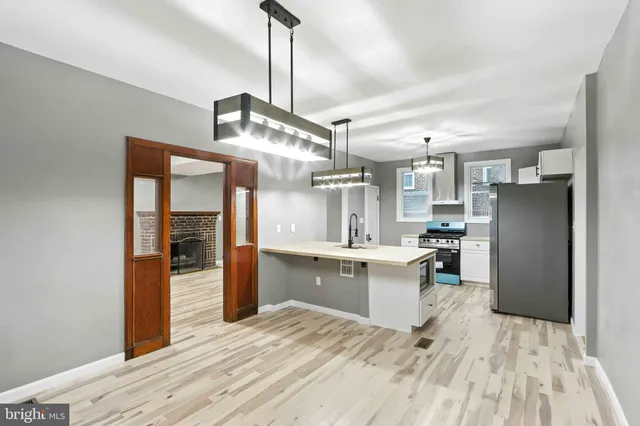 a kitchen with stainless steel appliances a refrigerator sink and stove
