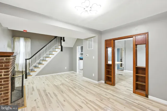 a view of entryway with wooden floor and stairs
