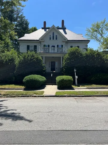 a front view of a house with a yard garage and outdoor seating