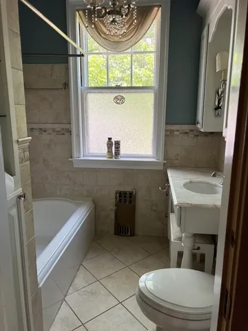 a bathroom with a sink a toilet and a bathtub