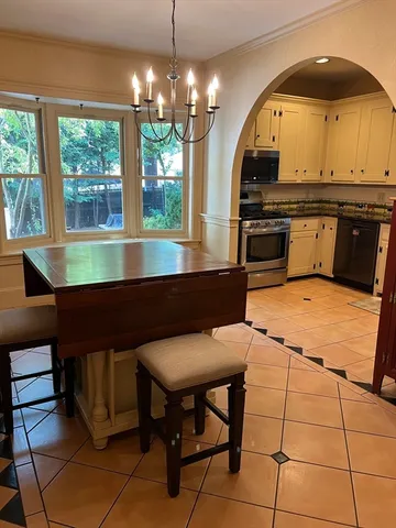 a kitchen with a table and chairs in it