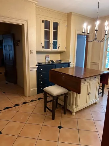 a room with furniture a mirror and a chandelier