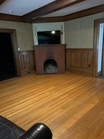 a view of a livingroom with an empty space and a fireplace