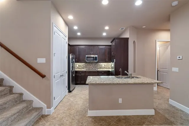 a spacious bathroom with a granite countertop sink a mirror and a shower
