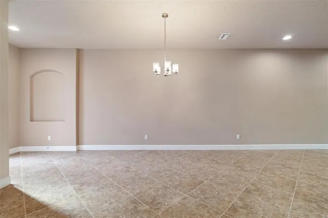 an empty room with windows and outdoor view