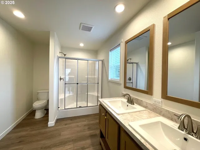 a spacious bathroom with a double vanity sink and mirror