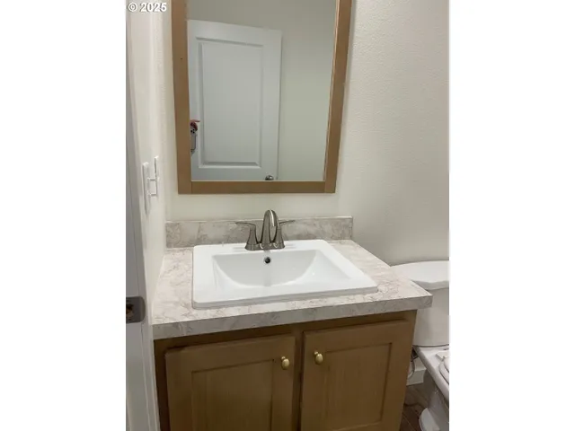 an empty room with wooden floor and window