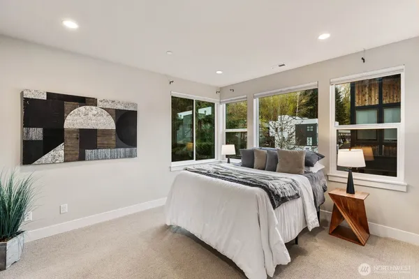 a bedroom with a large bed and a large window