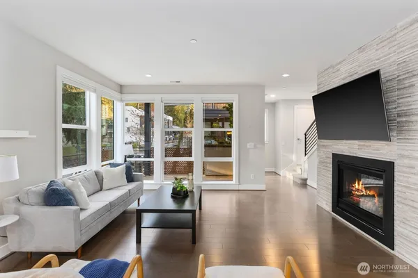 a living room with furniture a fireplace and a flat screen tv
