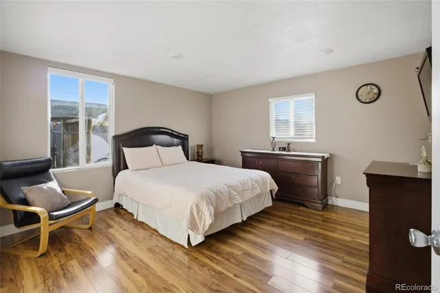 a bedroom with a bed and wooden floor