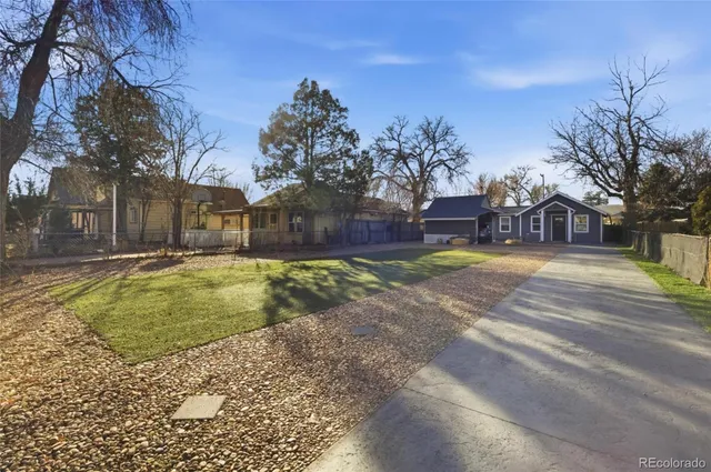 a view of swimming pool with outdoor seating and yard in the back