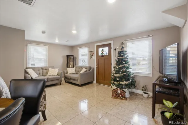 a living room with furniture gym equipment and a large window