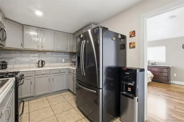 a kitchen with a refrigerator sink and cabinets