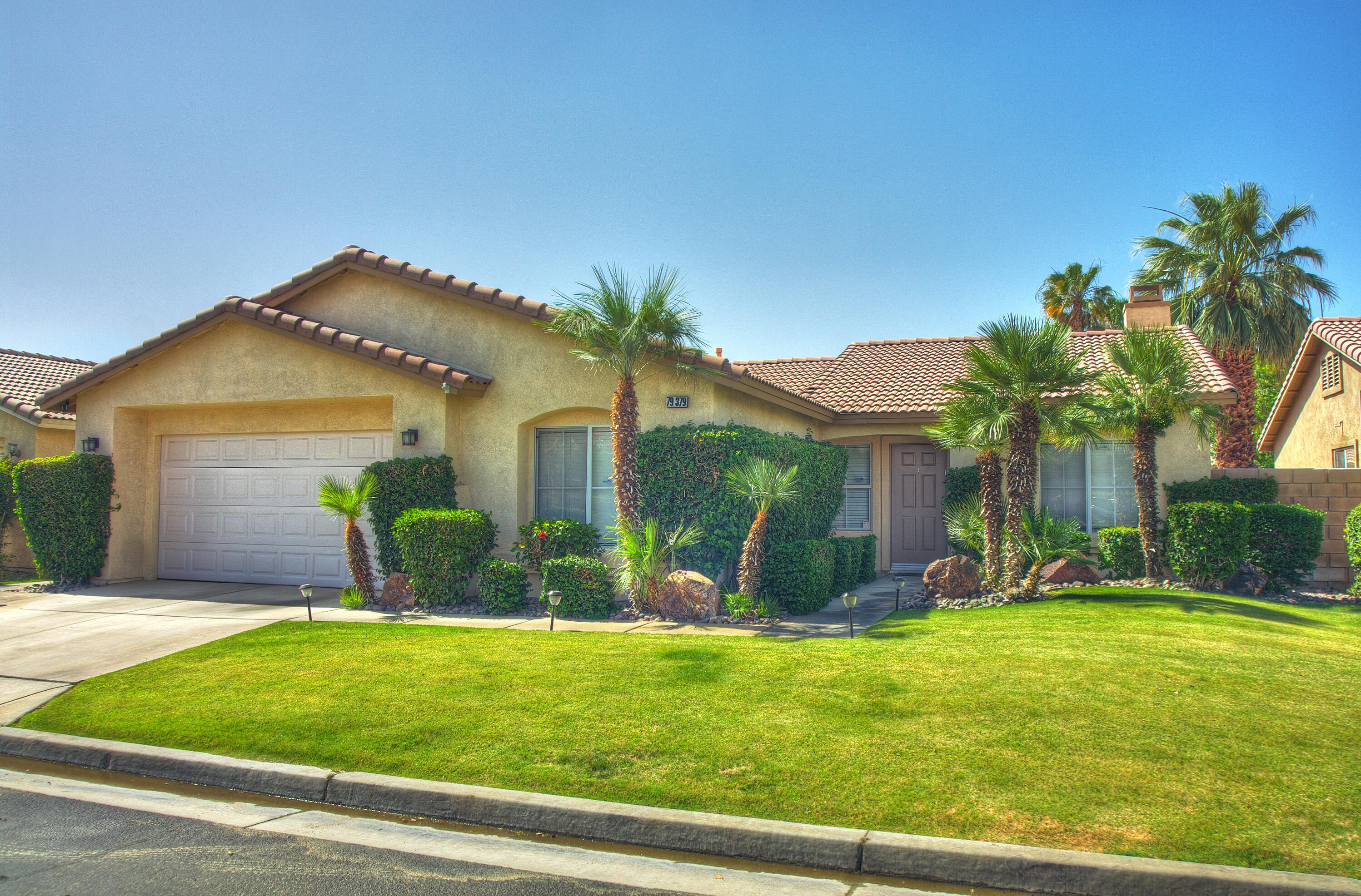 79379 Paseo Del Rey La Quinta, CA 92253 - Photo 1 of 24 a front view of house with yard and swimming pool