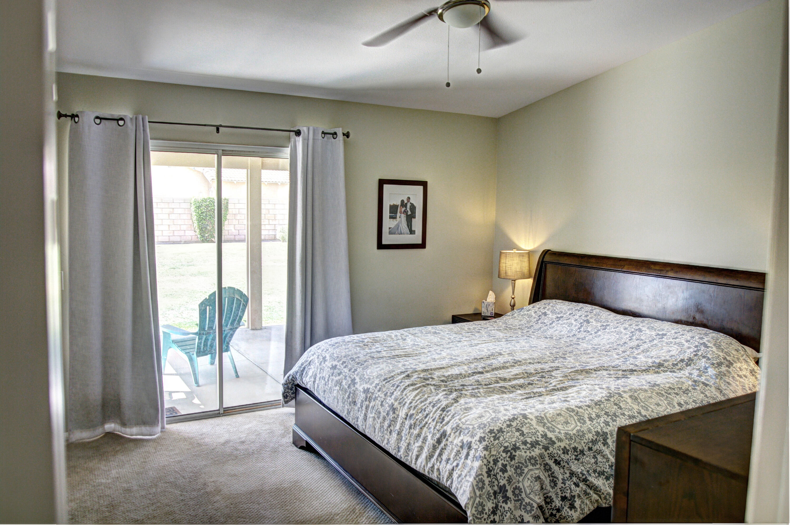 79379 Paseo Del Rey La Quinta, CA 92253 - Photo 11 of 24 a bedroom with a large bed and a large window