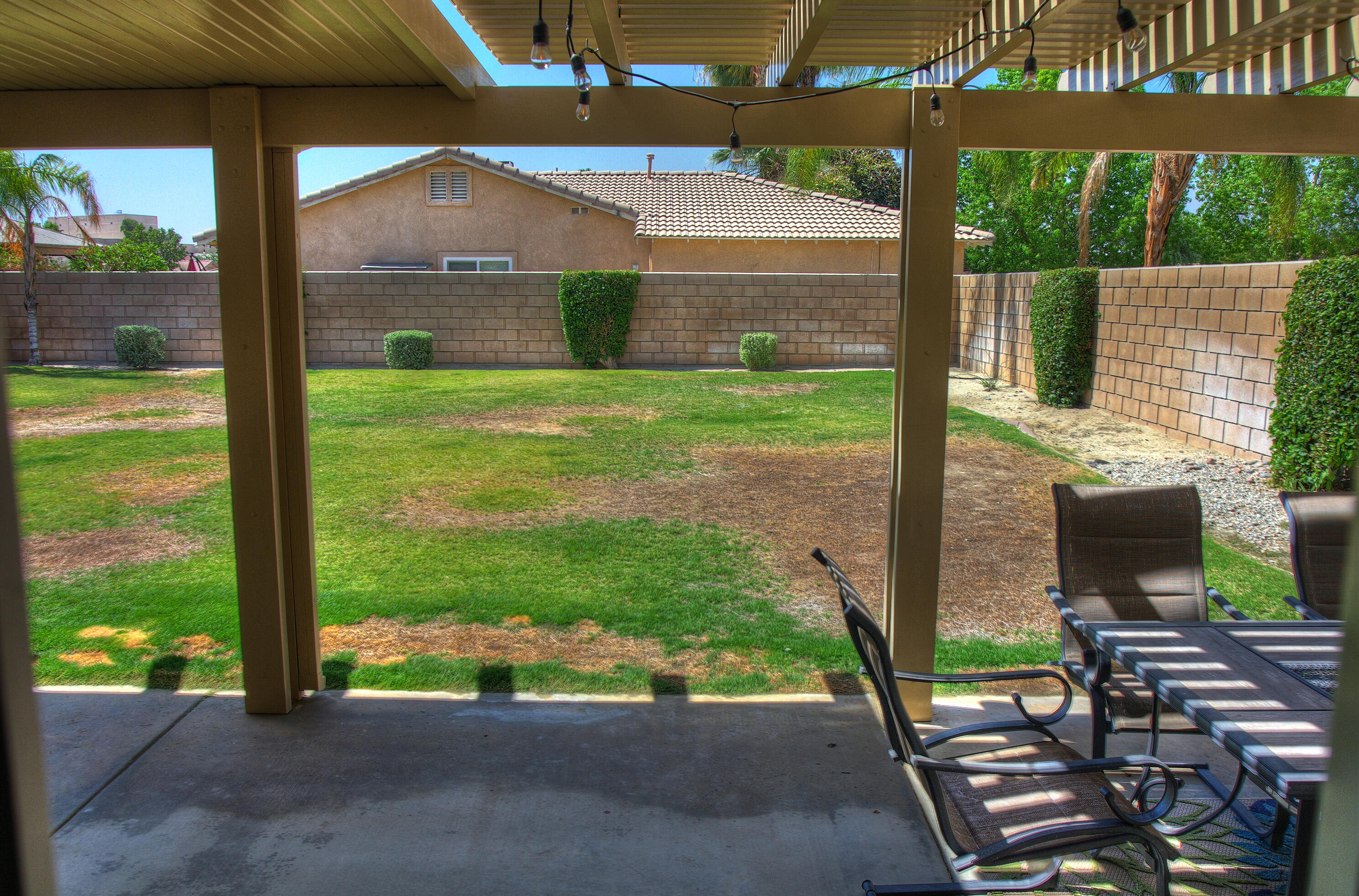 79379 Paseo Del Rey La Quinta, CA 92253 - Photo 19 of 24 a view of a patio with table and chairs under an umbrella
