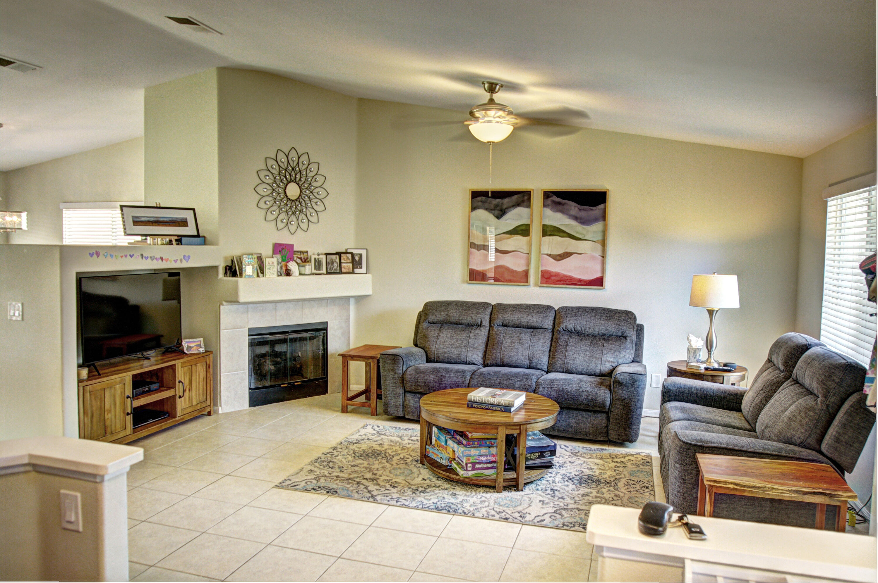 79379 Paseo Del Rey La Quinta, CA 92253 - Photo 2 of 24 a living room with furniture a fireplace and a flat screen tv